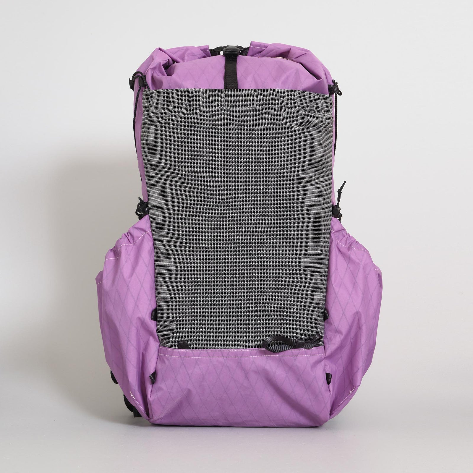 A purple (mulberry) hiking backpack, with a grey front stretch pocket hiking l and purple (mulberry) side pockets, photographed against a neutral light gray background. 