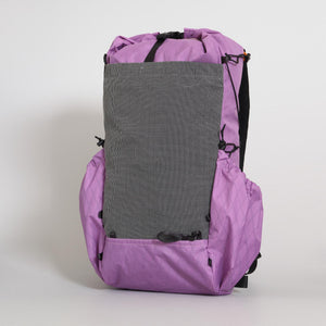 Ultralight hiking backpack OB30 in mulberry (purple) colour. The main compartment is packed and three external pockets empty. Front pocket is made from dark grey stretch mesh.