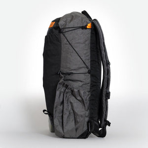 Sideview of a small black and grey hiking backpack with side pocket. Handmade by OrangeBrown Australia.