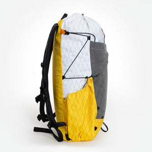 Sideview of a yellow/white backpack with side pocket. Made by OrangeBrown Australia.