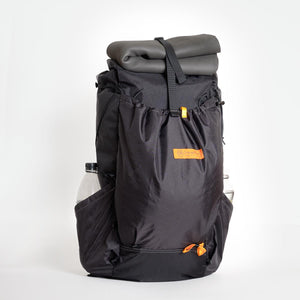 OrangeBrown backpack OB 36 with a fully stuffed front pocket, a 3mm PE foam mat tucked under the roll top strap and a water bottle carried in the side pocket.