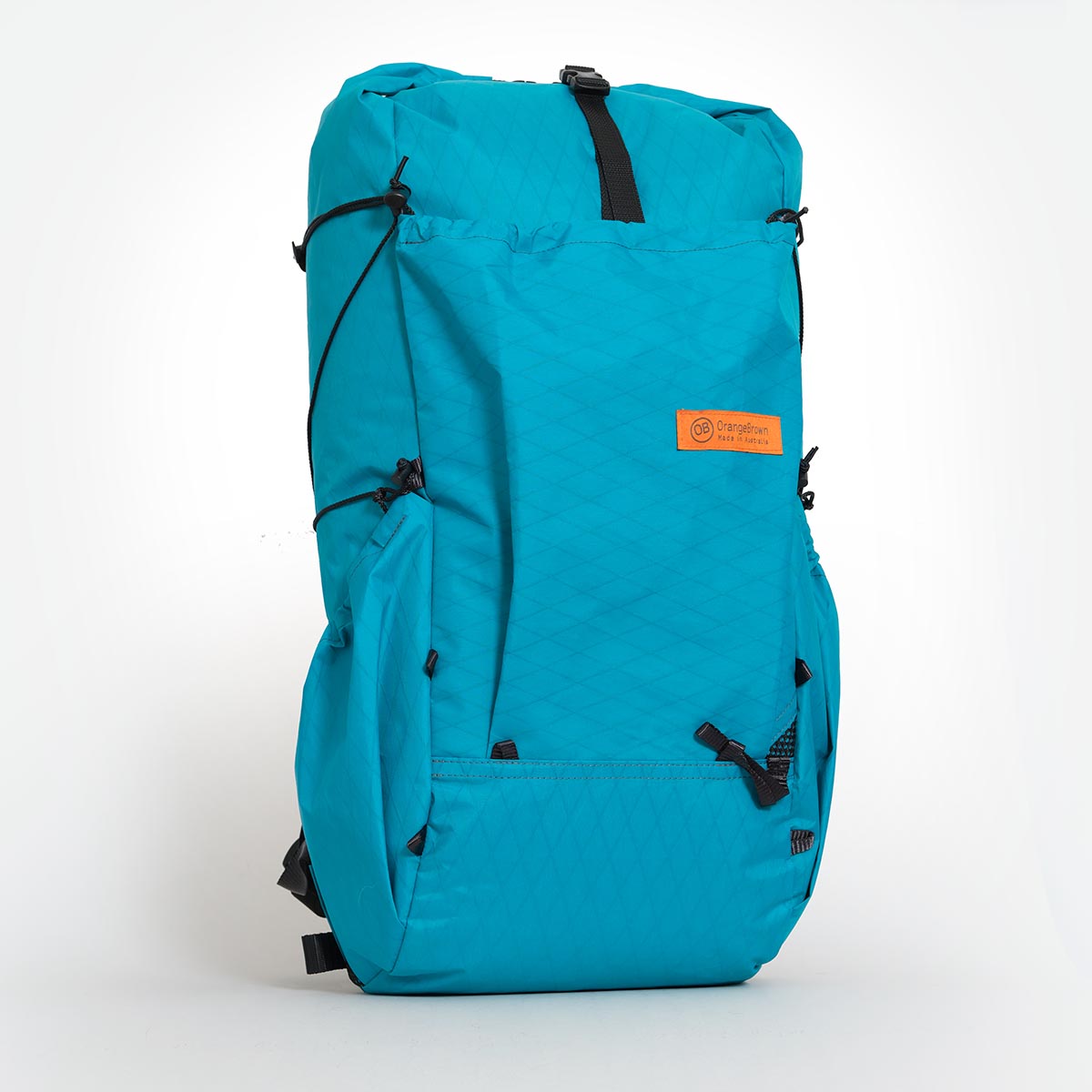 Teal hiking backpack made by Orangebrown. Featuring a front and two side pockets. Made from X-Pac VX21 fabric