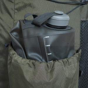 The tall left side pocket  of the OB48 backpack is made for extra storage. Holds a HydraPak Seeker 4L bladder.