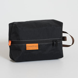 OrangeBrown packing cube made from black VX21 X-Pac fabric . YKK zipper #3 with two sliders for easy opening and a webbing loop for hanging. 