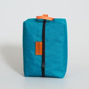 Packing acking cell made from teal coloured X-Pac VX21 X-Pac fabric . YKK zipper #3 with two sliders for easy opening and a webbing loop for hanging. Made in Australia