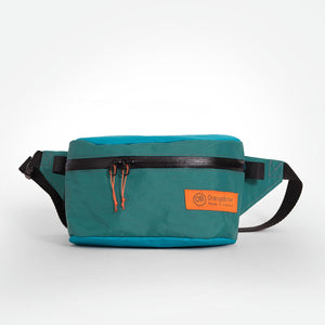 Teal and green waist bag with black strap made from X-Pac VX21 fabric.