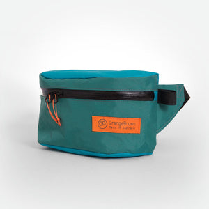 Teal and green waist bag with black strap made from X-Pac VX21 fabric.