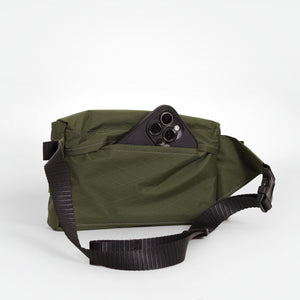 Dark green bum bag made from X-Pac VX21 fabric. With a secret pocket on the back and a YKK #5 zipper for the main compartment.