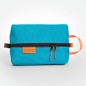 Teal coloured packing cube made from VX21 X-Pac fabric . YKK zipper #3 with two sliders for easy opening and a webbing loop for hanging. Made in Australia