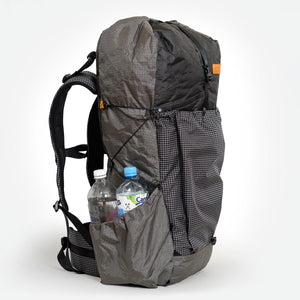 Sideview of OrangeBrown OB55 backpack. Compression cord and large side pocket.
