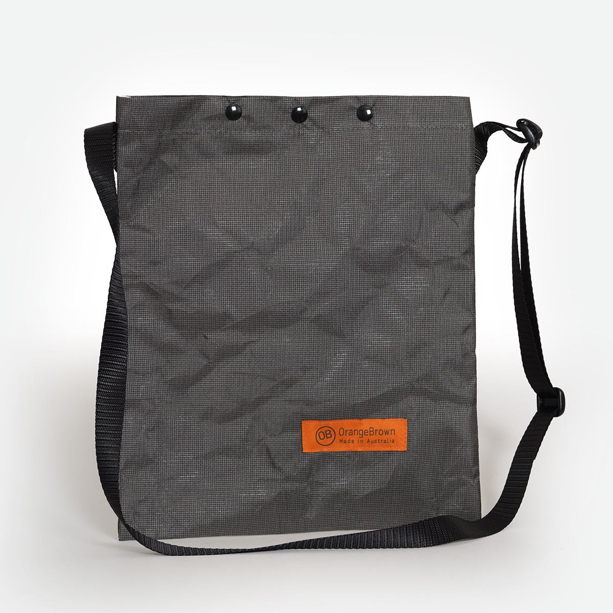 The lightest sling bag in the OrangeBrown collection made from grey Ultra200X fabric.