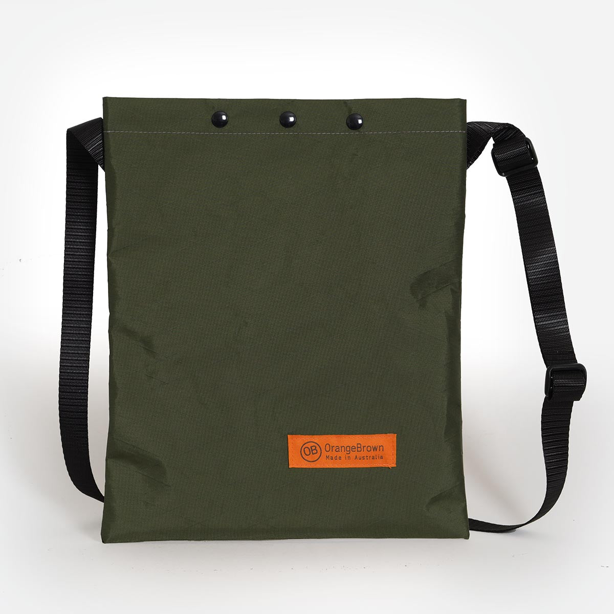 A cross body bag in dark green VX21 fabric and three press studs for closure