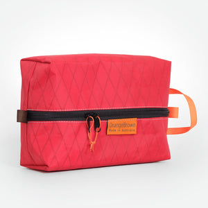 Packing cell made from red X-Pac VX21 fabric . YKK zipper #3 with two sliders for easy opening and a webbing loop for hanging. Made in Australia