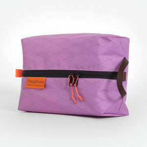 Pale purple packing cell for travel and hiking made from mulberry X-Pac fabric VX21. YKK zipper #3 with two sliders for easy opening and a webbing loop for hanging. Made in Australia.