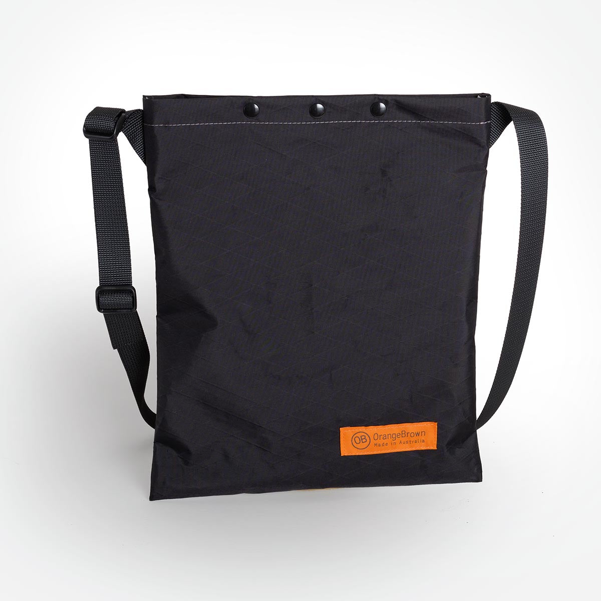 A black sling bag made by OrangeBrown in Australia.