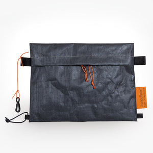 Sternum strap bag made from X-Pac Liteskin 07 fabric. Slides over the sternum strap of a backpack and is fixed to it with a short cord and mitten hook.