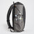 Sideview of OrangeBrown backpack OB30. The side compression cord holding down the second bottle which  is in the side pocket.